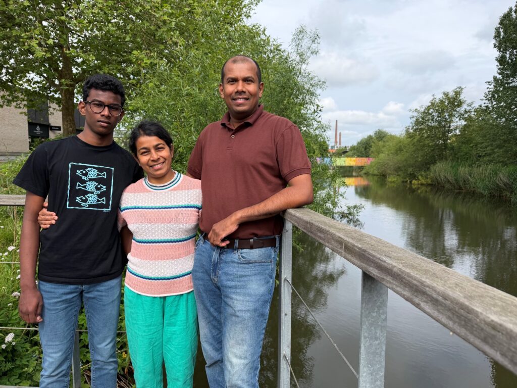 Sihela, Uddami og Eranga står samlet ved et gelænder med Kolding Å i baggrunden